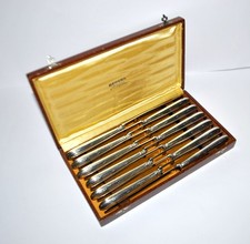 RENEKA Lot 12 couteaux de table Rubans croisés nœuds en métal argenté 24.5cm