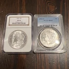 2x Graded Morgan Silver Dollars - NGC 1885 S$1 MS64 + PCGS 1883-0 MS63