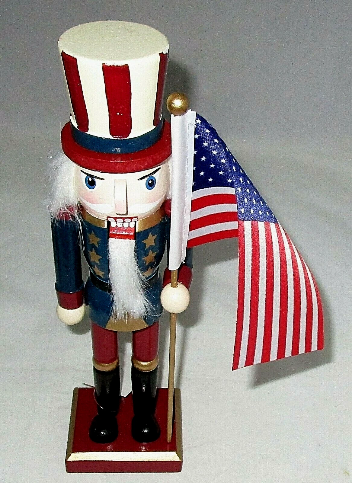PATRIOTIC NUTCRACKER ~ 10 inches ~ PRIMATIVE UNCLE SAM HOLDING AMERICAN FLAG