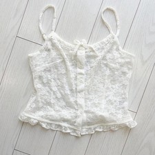 White lace cami top with button front and ruffle hem from Brandy Melville