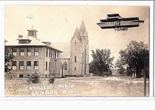 Surreal RPPC - Exaggeration Airplane near Catholic Church Lyndon Wisconsin