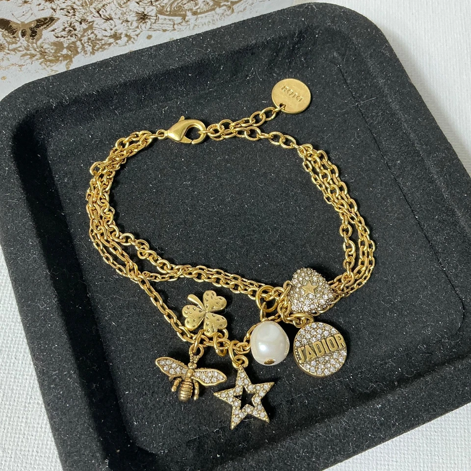 Pulsera con logotipo dorado Dior con caja Foto 3 de 3