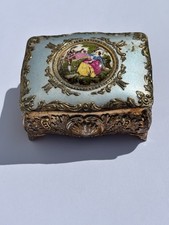 Ornate rectangular gold trinket box with victorian scene and red liner