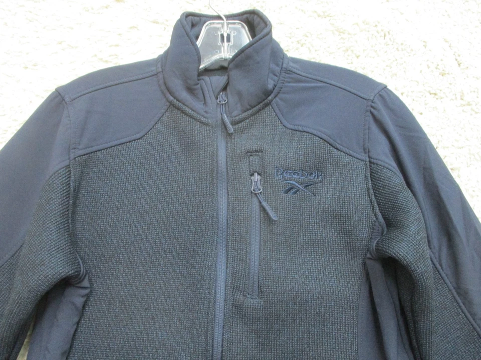 Suéter Reebok Mediano Juvenil Azul Marino Cremallera Completa Bolsillos Cuello Alto Logo Niños YMD Foto 2 de 4