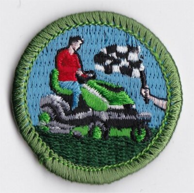 MERIT BADGE - SPOOF - LAWN MOWER RACING - 1-1/2'' DIA. - PRIVATE ISSUE