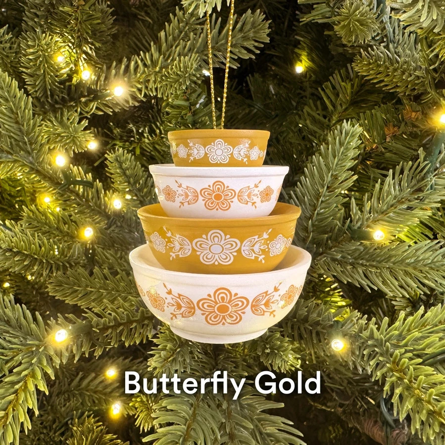 Hand-painted miniature ornaments styled after iconic Pyrex bowls — a clever nod for anyone who loses their mind over vintage kitchenware.