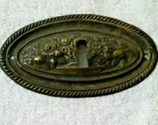 Old European Oval Metal Lock Plate with a Central Raised Floral Décor