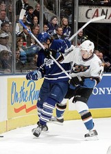 Nik Antropov Toronto Maple Leafs is taken into the boards by- Ice Hockey Photo