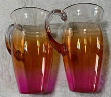 NEW Set Of Two Plastic 52 oz Pitchers 8.25" Tall Clear w/Orange Pink Hue