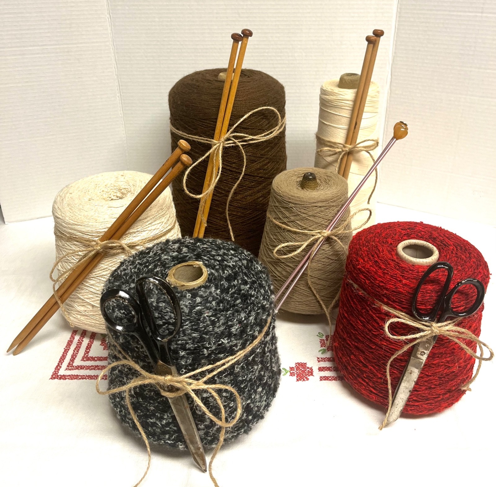 Assorted large vintage yarn cones with knitting needles crochet hooks scissors, vintage home decor