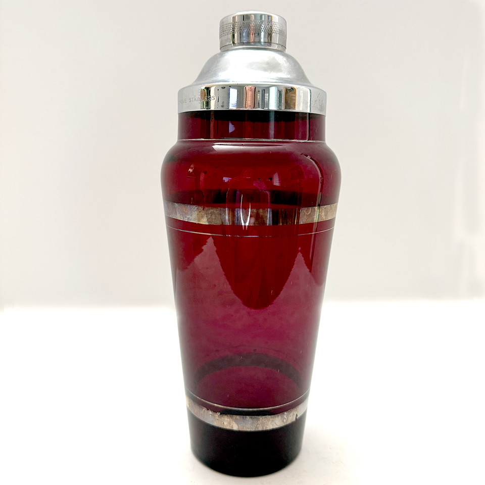 Ruby red glass and chrome Art Deco cocktail shaker — that deep red color with chrome hardware is visually stunning and unmistakably 1930s glamour.