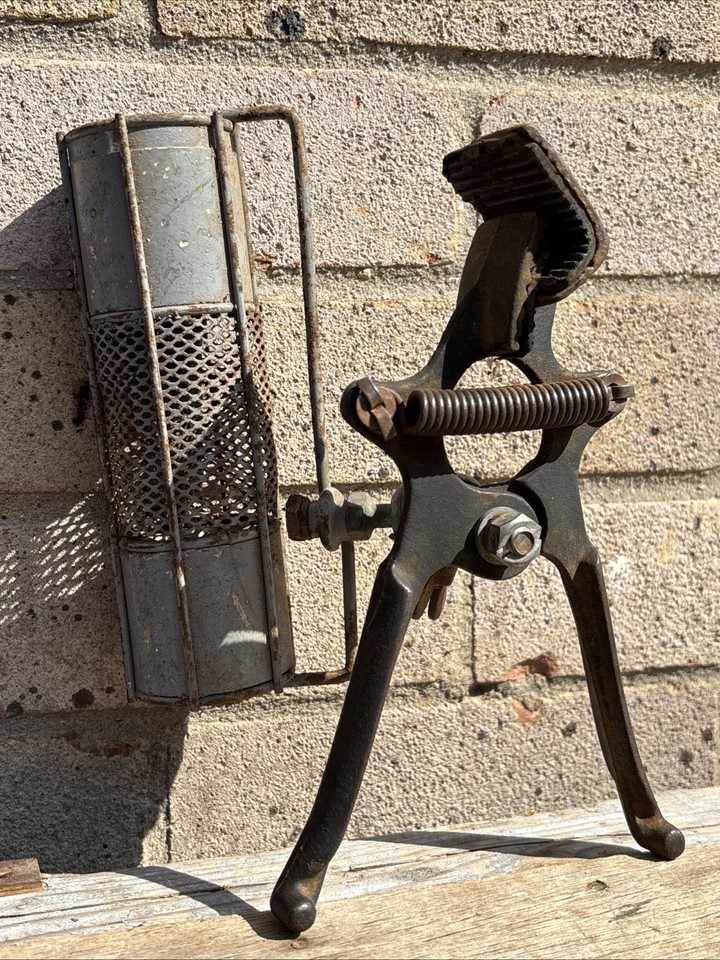 An industrial-era clip-on metal lamp that doubles as a rare hand tool artifact — genuinely atmospheric and functional as a workshop or shelf accent.