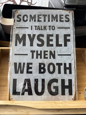 displays a retro-style metal tin sign with a humorous saying