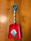 Vintage 1950s children's sand shovel manufactured by the Ohio Art Company, featu