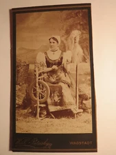 Wagstadt - sitting woman in costume with spinning wheel - backdrop - name? / CDV