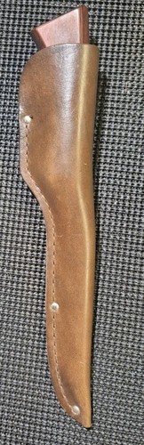 Brown leather Western fish fillet knife with flat rectangular blade and polished handle, sheath on black background.