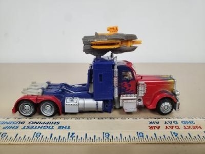 TRANSFORMERS OPTIMUS PRIME DOTM DELUXE CLASS (NLG057290)