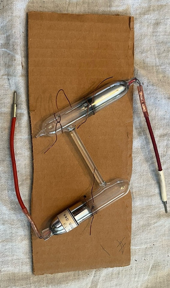 Actual sealed Krypton gas display tubes with electric leads from a vintage scientific supplier — glowing, eerie, and straight out of a mad scientist's lab.