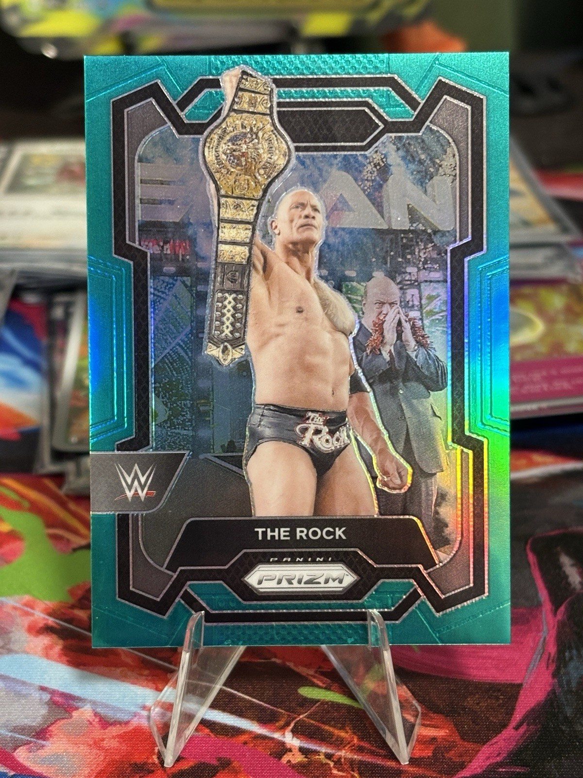 2024 Panini Prizm WWE The Rock Teal Prizm #34/49
