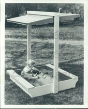 1964 Press Photo Adorable Toddler Plays in Sandbox With Canopy