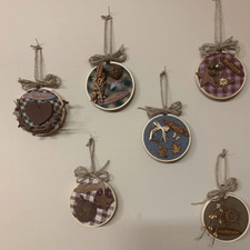 This listing is six 4 inch circle frames decorated with rustic decor. Inv 95