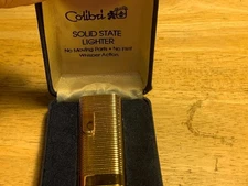 Colibri Gold Tone Solid State Lighter in Original box with Instructions