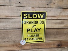 SLOW GRAND KIDS AT PLAY, warning sign, caution, be careful, road sign, safety