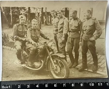 young guys on a motorcycle with a cigarette, soldiers in uniform, old photo