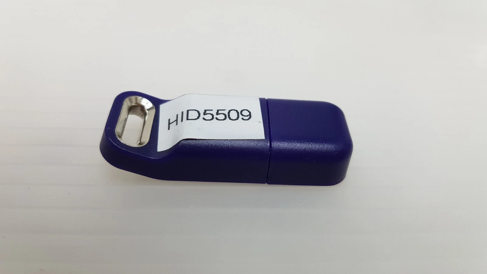 Reverse side of the Lumenis Quattro KT-11473370 key with white code sticker