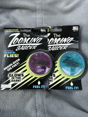The Zooming Saucer Rubber Disc Glows N Dark Floats Flys  Toy PURPLE & BLUE 2 Ct