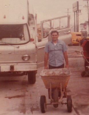 Man with Construction Equipment Industrial Setting Wheelbarrow Hard Work