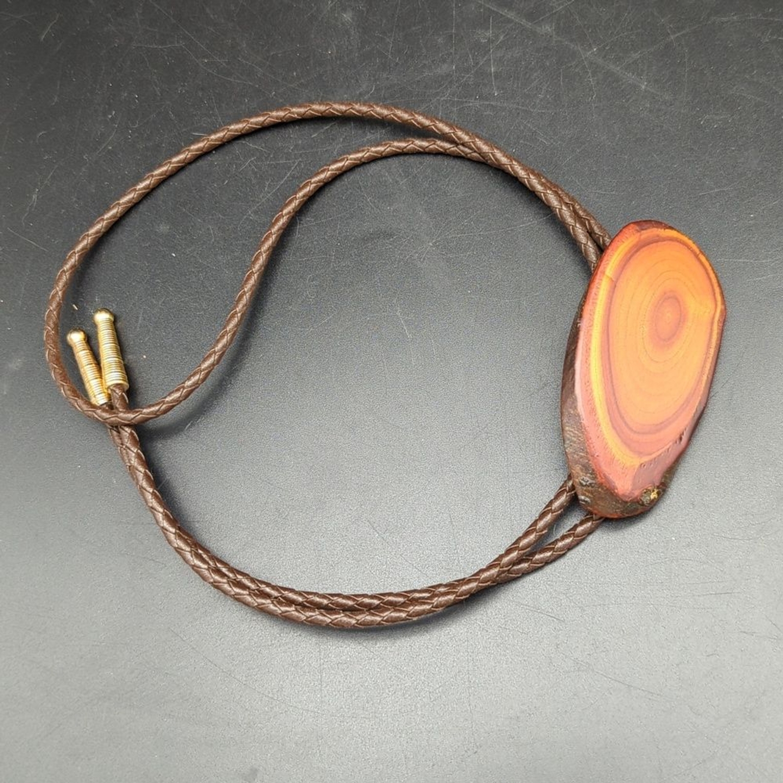 Western wood cross section leather cord bolo tie Gem