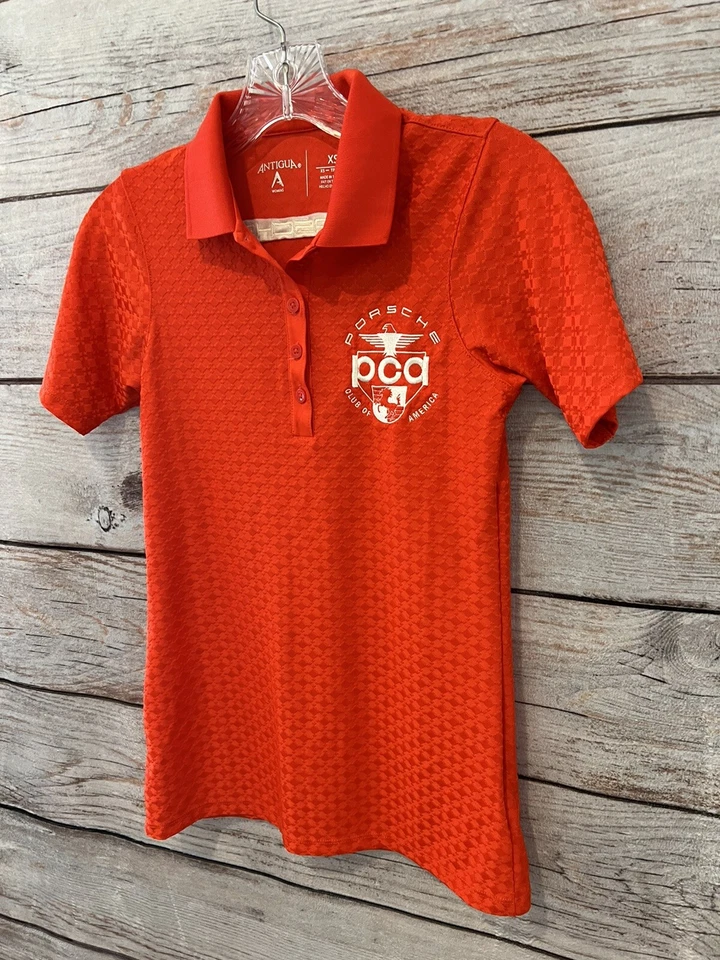 Polo de golf Antigua color rojizo/naranja PORCHE Club of America elástico para mujer XS Foto 2 de 4