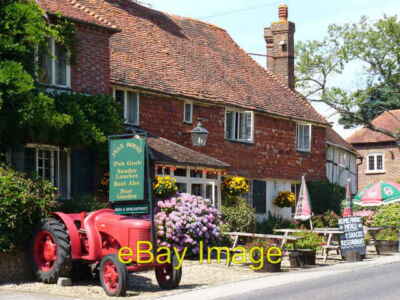Photo 6x4 The Half Moon Northchapel. The gaudy red tractor and floral di c2006