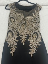 Women's black A-line evening gown with gold diamond design on the front and back