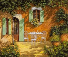 ceramic tile mural backsplash. Coffee on a patio in Tuscany Italy garden