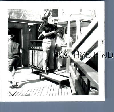 FOUND B&W PHOTO G+0963 MAN POSED BY WOMAN GETTING OFF SKY LIFT