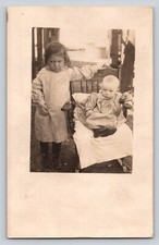 RPPC unhappy girl baby chair dress leather shoes Postcard Portrait Real Photo