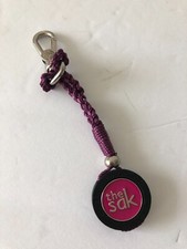 The SAK Handbag Charm Key Chain Antique Nickel Logo Pink Wine new