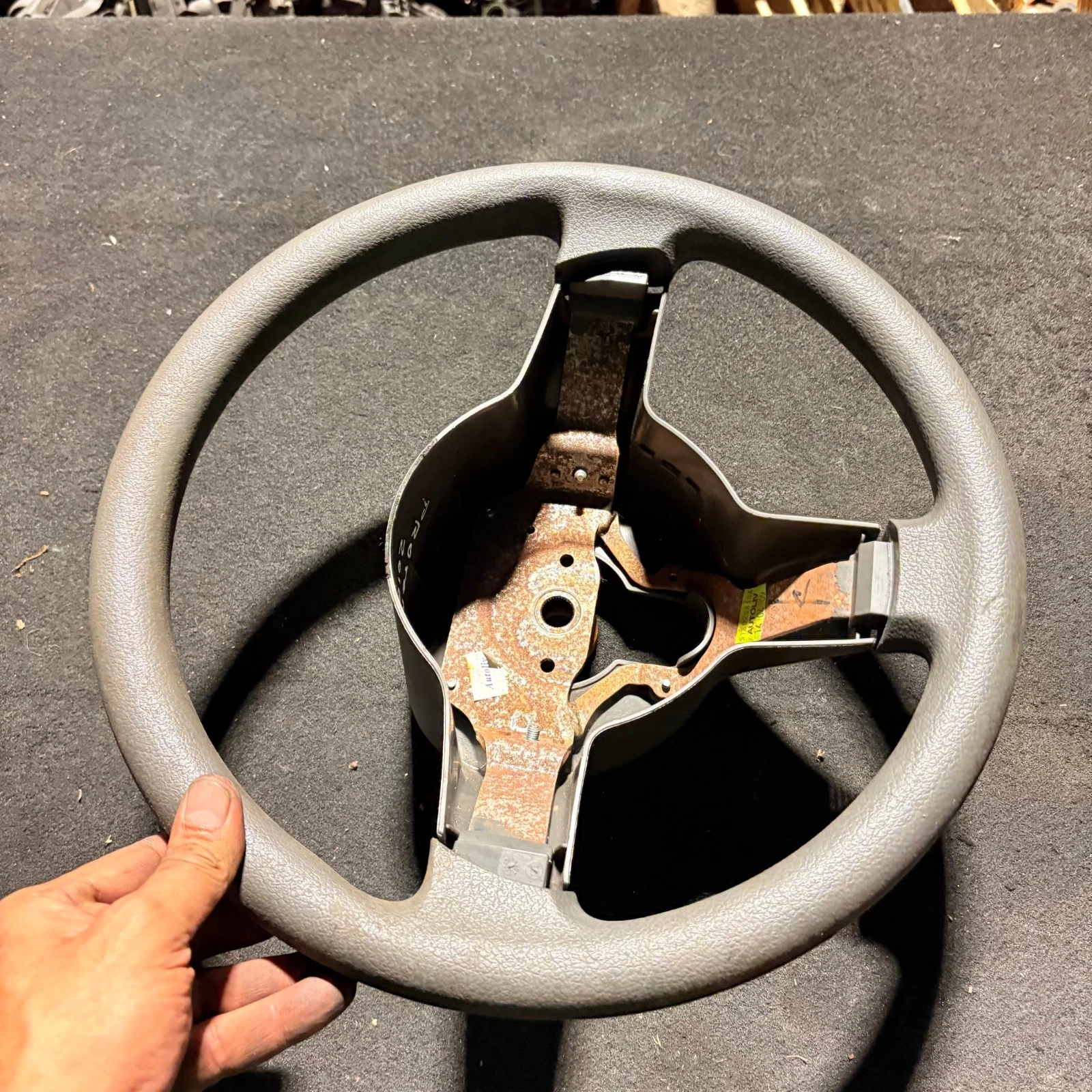 Actual Proton Savvy grey three-spoke bare steering wheel front view