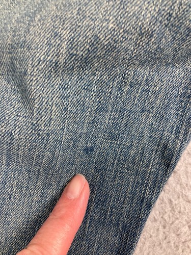 Close-up of blue denim fabric with fine textured weave, slightly faded wash, and “Karen Kane Lifestyle Jeans” tag.