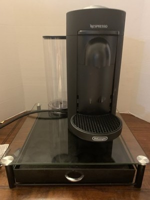 Nespresso De Longhi Vertuo Plus Coffee & espresso, sits on glass top base drawer