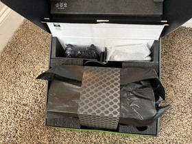 Microsoft Xbox Series X 1TB Console with two Microsoft controllers, battery pack