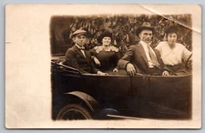 Two well dressed Couples riding in a convertible Ford Real Photo RPPC Oct 1917