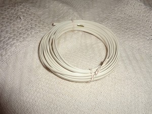 about 25 ft. of landline phone cable flat and white. no fixtures on the ends