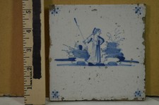 18th century Delft tile,,blue  white,appears to be a "topless" shepherdess.