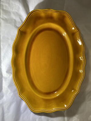 Plat ovale à bords mouvementés en faïence émaillée polychrome, à décor