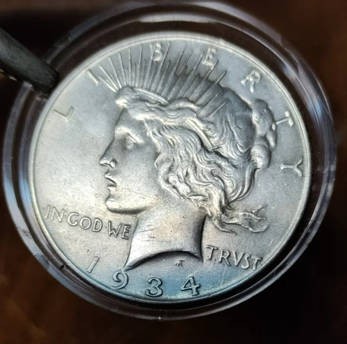 1934 PEACE SILVER DOLLAR. VF
