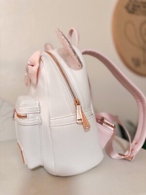 iridescent pink mini backpack Current Mood Fairy Wing This dazzling design comes in white topped off with sparkling sequins in a pink cotton candy hue on Minnies trademark bow and ears Loungefly Disney Minnie Mouse Iridescent