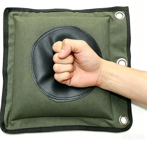 Green canvas leather wall bag with black circular punching hole, shown to be struck with a black fist on a red background.